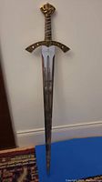Full-length view of the 39-inch decorative replica sword showing blade, hilt, and pommel.