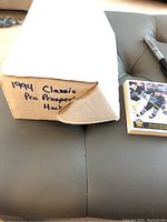 Photo of worn, opened box labeled '1994 Classic Pro Prospects Hockey' with partial view of one hockey card next to it
