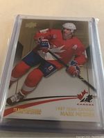 Front view of 2015 Upper Deck Team Canada Mark Messier hockey card in protective sleeve, showing player in Team Canada uniform and card numbering 330/499.