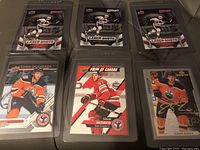 Front view of 6 Connor McDavid hockey cards in sleeves showing player images and designs