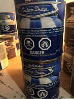 Two stacked cans of Dupli-Color Deep Blue Coat spray paint in deep blue color, 946 ml each, showing brand and hazard labels.