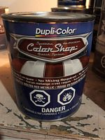 Photo shows a metal can of Dupli-Color Color Shop Molten Red Metallic automotive lacquer paint with warning symbols.