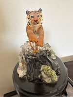 Front view of Lenox tiger figurine splashing in water with detailed painted features and water splash effects