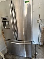 Front view of stainless steel Samsung French door refrigerator with bottom freezer drawer