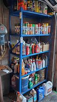 Front view of blue metal shelf unit filled with various cans and bottles, for identifying the shelf and contents which are excluded.