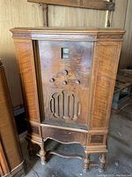Full view of the vintage floor-standing Stromberg Carlson radio showing wooden cabinet, front panel controls, and speaker grill.