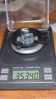 Blue sapphire crystals on digital scale displaying total weight of 35.34 carats.