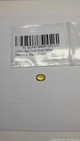 Natural canary yellow sapphire in oval cut on white background with identification label showing carat and size.