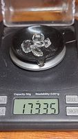 Five mixed cut natural crystal quartz gemstones displayed on a digital scale showing total weight of 17.33 carats.