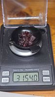 Garnet crystals weighing 31.54 carats on a digital scale