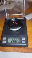 Garnet stones on a precision digital scale showing total weight 2.005 carats.
