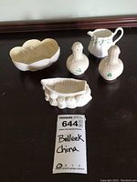 Overview of all five pieces including the shell salt and pepper shakers, shell bowl, row boat trinket dish, and Royal Tara creamer.