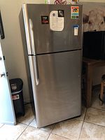 Front exterior view of stainless steel Frigidaire refrigerator.