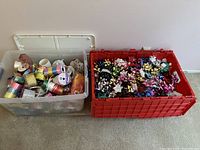 Overview of two large plastic containers filled with decorative bows and ribbon spools