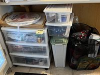 Rolling cabinet with clear drawers and stackable containers for miscellaneous household and gardening items