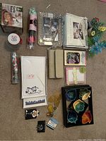 Overview of all items including frames, pins, stationery, floral confetti, dishes, and artificial flowers
