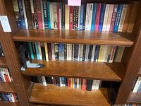 Photo showing three shelves filled with books including biographical, historical, and literary works.