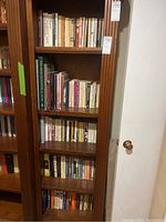 Five shelves filled with books spanning political, history, philosophy, and self-help genres.