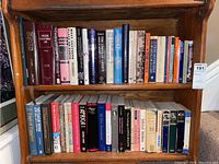 Books arranged on wooden shelves showing titles related to law and history.