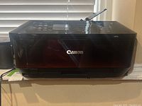 Front view of black Canon copier showing Canon branding and MX922 model number.