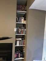 View of built-in shelving with multiple rows containing DVDs and CDs collections and boxed sets.