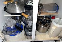 Food processor with surrounding glass dishes, steel pot, and plastic container