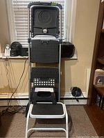 Cosco step ladder unfolded showing three anti-slip steps and top platform, silver frame with black steps.