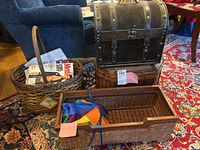 Overview photo showing two trunks stacked and two baskets with magazines
