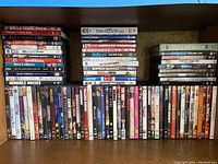 All DVDs stacked in rows viewed from above showing titles and arrangement.