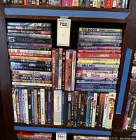 Shelf loaded with DVDs primarily Hollywood musicals from 1940s to 1960s song and dance, including Star Trek, Speak Easily, Out of Africa, and other titles.