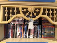 Photo of DVD collection on shelf showing various titles including Tyson, Ali, Raging Bull, When We Were Kings, Saturday Night Live, Mystery Alaska, Necessary Roughness, Cabin Boy, and others.