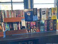 Photo showing multiple DVD titles arranged on a shelf with light coming through a window, including music and classic movie box sets.