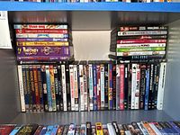 Shelf of various DVDs organized side by side showing titles like Pee Wee's Big Adventure, Marx Brothers, Timescape, Crime Spree, and more.
