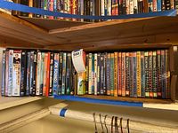 Top view of a box of assorted DVDs including many SNL collections, Monty Python, Wag The Dog and more