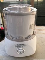 Front view showing the Cuisinart logo, on/off switch, and white base with mixing bowl.