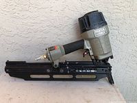 Side profile of the Porter Cable pneumatic nailer showing body, handle, and nail magazine