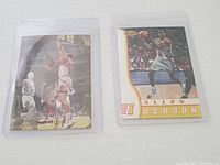 Two Allen Iverson rookie basketball cards side by side in clear protective sleeves, showing action and shooting poses.