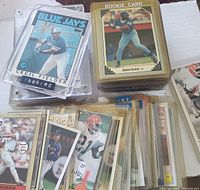 View of collection showing many baseball cards, including Cecil Fielder and Brian McRae rookie cards with several others beneath