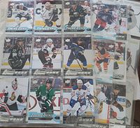 Photo showing multiple hockey cards, mostly from the 'Young Guns' series, each with a player in action during hockey games.