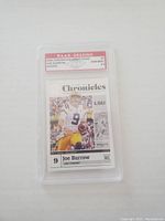 Front of Joe Burrow rookie card graded Gem Mint 10 by P.A.A.S., showing player in LSU uniform with card details.