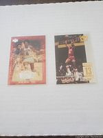 Two Julius Erving basketball trading cards displayed against a white background, one with a red border and the other showing a mid-air jump shot.