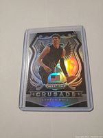 Front of LaMelo Ball rookie card with holographic Crusade design and refractor surface
