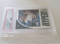 Front of the 2019 Panini Prizm Luka Doncic #11 basketball card graded PSA 10 showing player action and 'HYPED' text.