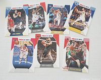 Photo of seven NBA Hoops basketball cards featuring players Luka Doncic, Kyle Lowry, Lonzo Ball, Steph Curry, Fred VanVleet, Pascal Siakam, and one partially visible card. Cards are arranged on a flat surface.