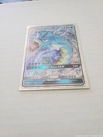 Front holographic side of the Gyarados GX Pokémon card showing artwork and details.