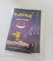 Two sealed Pokemon Trading Card Game Trick or Trade booster packs shown front view with Gengar and Pikachu artwork.