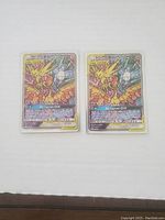 Two identical Pokemon Tag Team GX Legendary Birds holographic cards side by side.