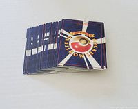 Lot showing multiple Pokémon cards stacked with backs visible featuring the classic 1996 card design.