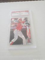 Front view of Shohei Ohtani baseball card graded and encased by P.A.A.A. Grading showing batting image and Angels logo.