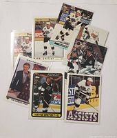 Front sides of multiple Wayne Gretzky hockey cards in protective sleeves, showing player images and action shots.